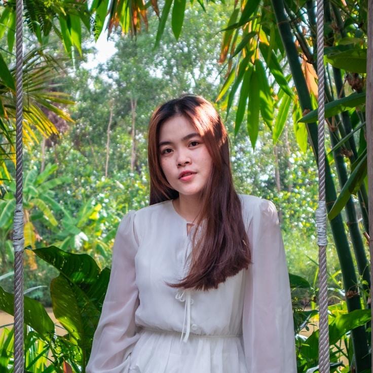 Avery Shah, Lead Design Curator at ThrumThicketGlimmer, reviewing corporate floral arrangements